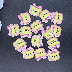 Detailed view of light green resin cartoon bear DIY accessories with pink bows
