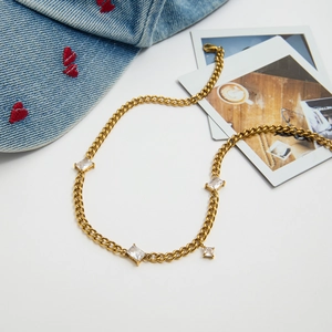 18K gold plated Cuban chain necklace with sparkling zircon stones on a stylish background