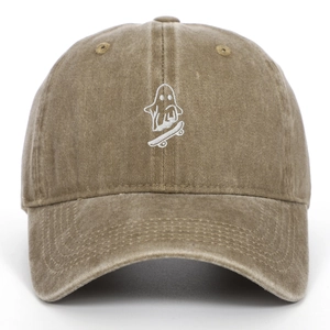 Detailed close-up of ghost skateboarder embroidery on washed khaki cotton baseball cap