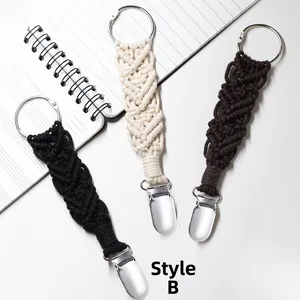 Detail of woven cotton hat clips with metal buckles in black, cream and coffee colors