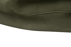 Close-up of military green half-zip sweatshirt showing rib-knit hem and stitching quality