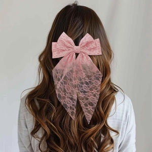 Elegant pink lace bow hair clip shown on model for a sweet and feminine hairstyle