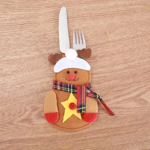 Detailed view of reindeer felt cutlery holder on rustic wooden table for Christmas decor