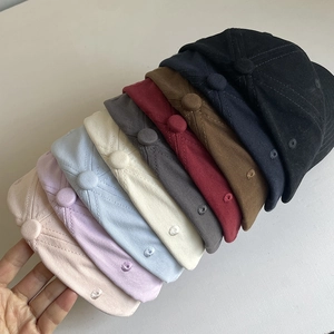 Side view of multi-color cotton baseball caps showing texture and metal eyelet details