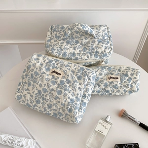 Macro detail of three-piece floral quilted storage bags with hisocute woven labels