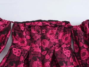 Close-up of deep pink jacquard floral fabric with off-shoulder and puff sleeve details
