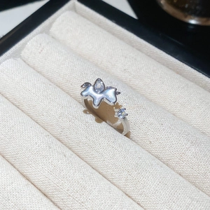 Close-up of adjustable silver star ring with mother of pearl and zircon stones