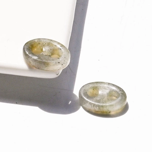 Close-up of translucent natural crystal resin buttons with unique internal grain textures