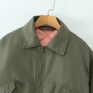 Army green flight jacket with pink quilted lining and classic lapel collar detail