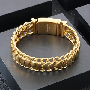 Close-up of gold 316L stainless steel woven keel chain bracelet with fold-over clasp