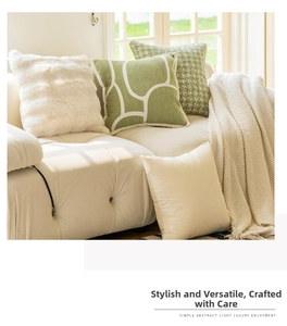 Detail of cream-style sofa covers in faux fur, sage green geometric, and floral textures