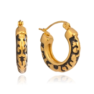 Macro shot of gold-plated hoop earrings featuring black leopard print enamel textures