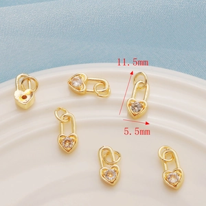 Detailed macro view showing 11.5mm x 5.5mm gold-plated heart charms with zircon inlay