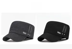Detail of wool flat top caps with metal V-logo in gray and black colors