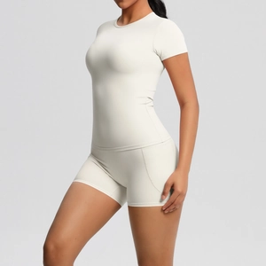 Close-up of cream yoga set showing seamless stitching and elastic nylon fabric texture
