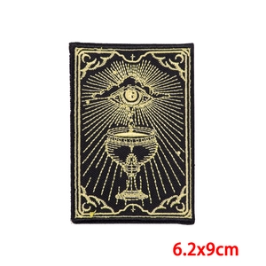 Detailed close-up of a 6.2x9cm Tarot Eye embroidery patch with golden mystic symbols