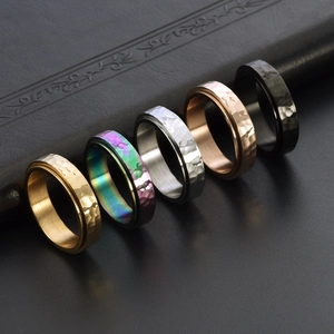 Five assorted titanium steel hammered rings in gold, silver, black, and rainbow colors