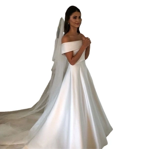 Elegant off-shoulder satin wedding dress with A-line skirt and long tulle veil