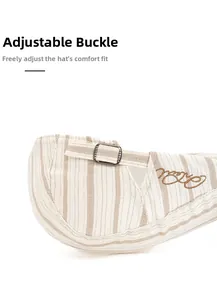 Detail of adjustable metal buckle and striped fabric on the vintage newsboy cap