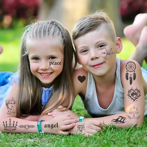 Kids temporary tattoos on arms and faces featuring peace signs, angels and crowns