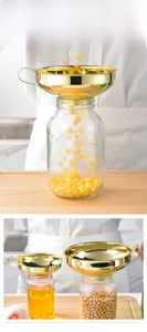 Macro detail of golden stainless steel wide mouth funnel for filling glass jars