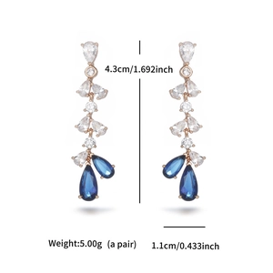 Macro view of blue drop gemstone earrings with rose gold settings and dimensions