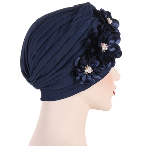 Navy blue pleated turban hat for women featuring three handmade flowers with pearls