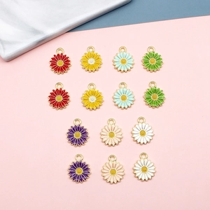 Flat lay of colorful daisy flower pendants in alloy oil drop finish for jewelry DIY