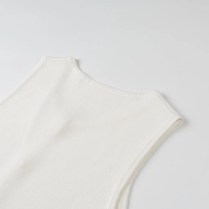 Detail of white sleeveless knit top showing fine stitching on the neckline and straps
