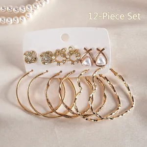 Detailed view of 12-piece gold hoop earring set with pearls and rhinestones on white card