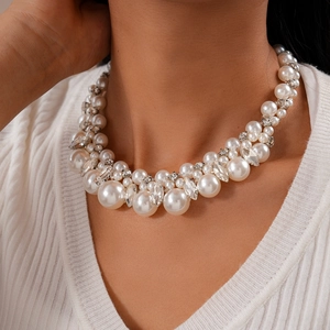 Detail of elegant multi-layer baroque pearl choker necklace with sparkling rhinestones