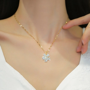 Titanium steel gold necklace with light blue flower zircon pendant worn by a model