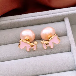 Pink freshwater pearl horse studs with 18K gold plating on elegant velvet jewelry tray