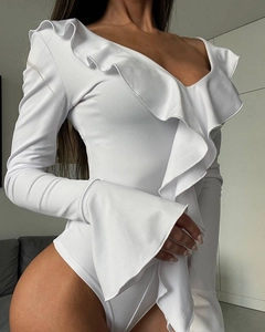 Dettaglio body bianco con scollo a V profondo, bordi a balze e design delle maniche a campana