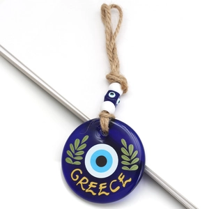 Close-up of blue glass evil eye pendant with Greece text and beaded twine strap