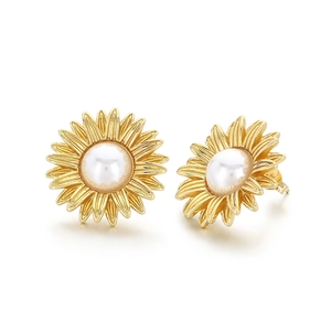 Golden sunflower earrings with white pearls in a 45-degree angle professional display