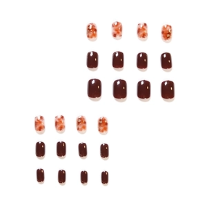Short amber and burgundy press-on nails with glossy resin finish and marble pattern