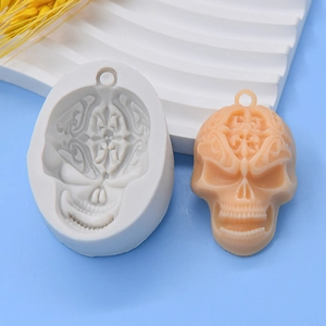 Detailed silicone mold showing intricate vintage skull carving and finished DIY resin pendant