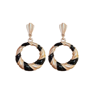Vintage style golden hoop earrings with black enamel twisted stripes and shell design