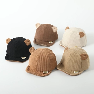Detail showing various colors of corduroy baby caps with cute bear ears decoration