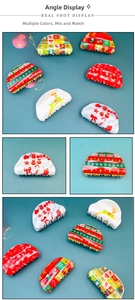 Detailed view of Christmas themed hair claws with festive reindeer and snowflake prints