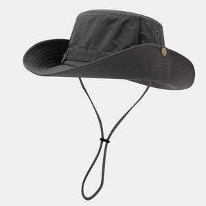 Detail of dark grey sun hat featuring breathable metal eyelets and adjustable wind cord