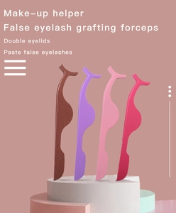 Close-up of colorful false eyelash applicators standing on geometric pedestals