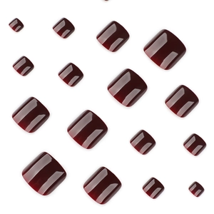 Glossy burgundy press-on toenails set in various sizes on a clean white background