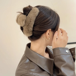 Detail view of large plush faux fur hair claw clip in brown for winter updos