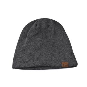 Deep grey knitted beanie hat for men and women featuring a brown leather F&S logo patch