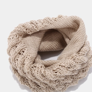 Detailed view of the chunky oatmeal knit wave texture on a warm infinity winter scarf