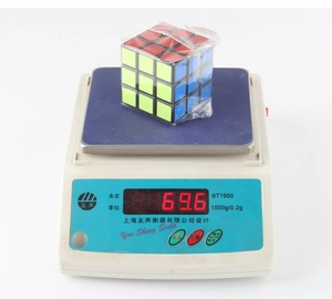 Macro shot showing the lightweight 3x3 speed cube on a scale weighing 69.6 grams