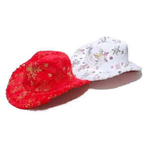 Detail of red and white plush cowboy hats with gold snowflake patterns for Christmas