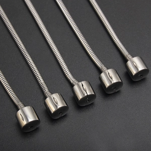 Macro detail of flexible silver stainless steel gooseneck hoses with metallic end caps